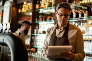 bartender looking at a document