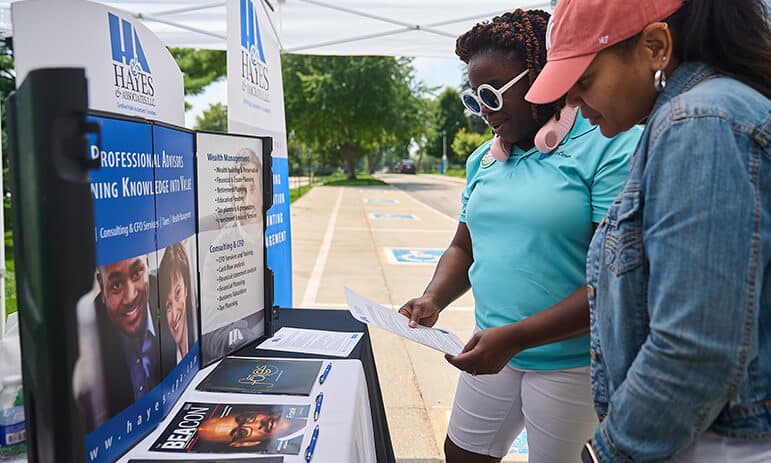 two women looking at a stand